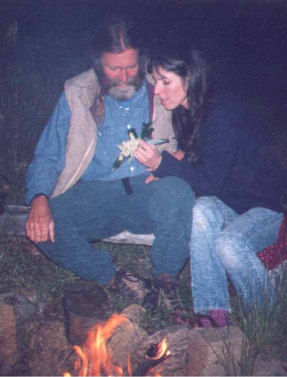 DEEP Faculty Chant and Susanna examine intricacy of madrone blossoms at the campfire.